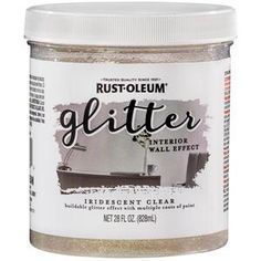 a jar of glitter next to a white wall