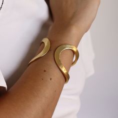 Designed to wrap your wrist in glistening shine, this sinuous wrist cuff is both sculptural and minimalist. * Cuff slightly adjustable to fit most *PRODUCT DETAILSMaterials: Pewter casting with either 24 kt gold plating / Sterling silver plating / Rose gold plating.Measurements: 2" width. As seen on Fifth Harmony Singer Camila Cabello: Wows the Teen Choice Awards crowd with her all black outfit and Elise split cuff she chooses to wear on her upper arm. This cuff is so volatile it can be worn man