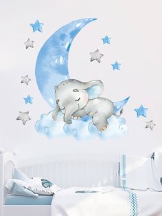 an elephant is sleeping on the moon wall sticker in this child's room