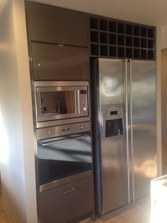 two stainless steel refrigerators side by side in a kitchen