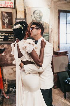 a man and woman in formal wear kissing each other