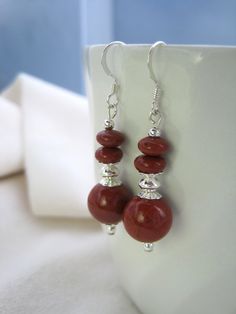 Handmade earrings featuring the beautiful Red Jasper complemented by elegant sterling silver beads.  These earrings provide a spot of color & shine to  wardrobe.  Goes great with black, brown, navy, taupe or beige. Red Jasper is a semiprecious stone.  The earrings drop a little over an inch from sterling silver ear wires. Red Sterling Silver Beaded Earrings Gift, Red Sterling Silver Beaded Earrings, Red Sterling Silver Nickel-free Beaded Earrings, Nickel-free Red Beaded Sterling Silver Earrings, Red Bead Earrings, Earrings Elegant, Brown Silver, Earrings Red, Earrings Drop