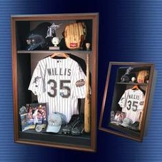 a baseball jersey and helmet are in a shadow box with the number 35 on it