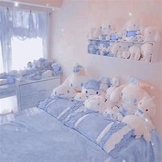 there are many teddy bears on the bed in this room, and one is blue