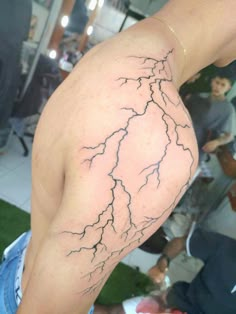 a man with a tattoo on his arm has a lightning bolt drawn on it's back