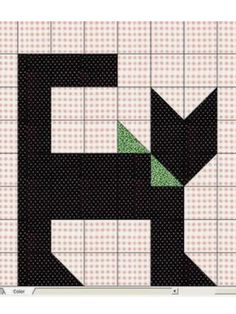 a black and white quilt with a green arrow