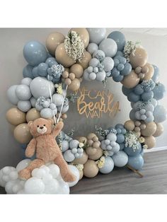 a balloon arch with a teddy bear on it