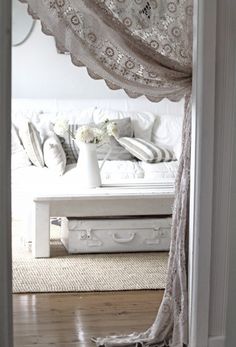 an open door leading to a living room with a couch and coffee table in it