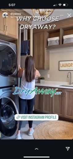 a woman standing in front of a washer and dryer next to a kitchen