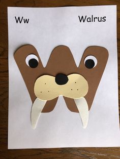 a paper cutout of a walrus with the word w on it's face