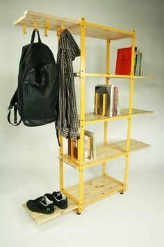 a book shelf with a backpack and shoes on it