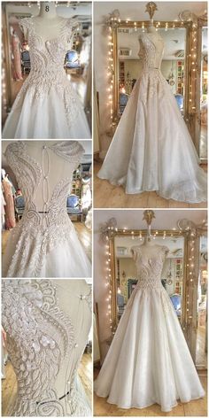 wedding gowns and dresses displayed in front of a mirror with lights on the wall