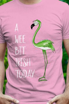 a man wearing a pink shirt with a flamingo on it