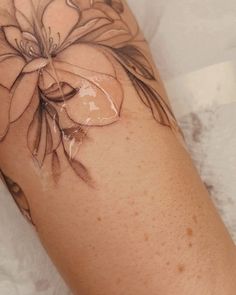 a close up of a person's arm with flowers on it