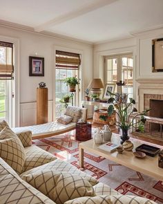 a living room filled with furniture and a fire place in the middle of a room