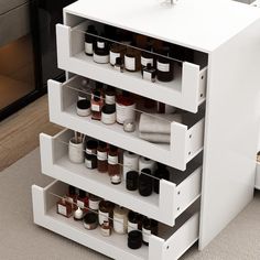 a white cabinet filled with lots of bottles