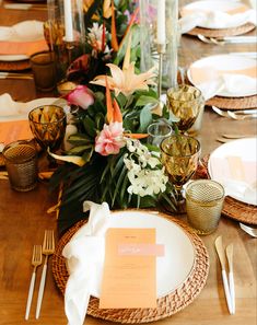 the table is set with flowers and place settings