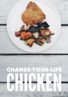 a white plate topped with chicken and veggies on top of a wooden table