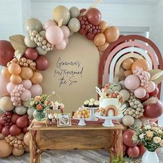 the dessert table is set up with balloons and flowers