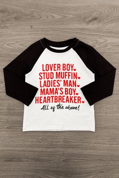 Top features "Lover Boy, Stud Muffin, Ladies' Man, Mama's Boy, Heartbreaker, All Of The Above!" on the front Long sleeve design makes it a perfect pick all season long Ultra-soft material for comfort & ease Perfect for Valentines' Day Your little heartbreaker will love wearing this "Lover Boy, Stud Muffin..." Long Sleeve Top. The top features long sleeves with an adorable saying embossed on the front. In a versatile black and white design, this top is made from soft and breathable fabric that wi Ladies Man, Stud Muffin, Black And White Design, White Design, Sleeve Designs, Soft Material, Breathable Fabric, Muffins