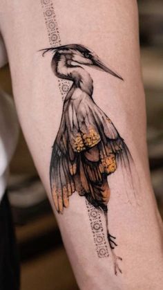 a tattoo with a bird on it's arm