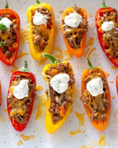 several stuffed peppers with cheese and meat on them