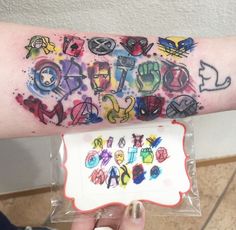 a person with a tattoo on their arm holding up a piece of paper that says happy birthday