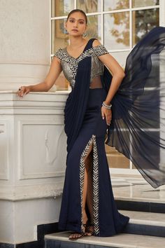 Navy blue pre-draped saree gown with bead, cutdana, sequin embroidery on yoke and asymmetric pallu.
Components: 1
Pattern: Embroidery
Type Of Work: Bead, cutdana, sequin
Neckline: Broad V neck
Sleeve Type: Cap sleeves
Fabric: Net, Satin Organza, Chiffon
Color: Blue
Other Details: 
Attached asymmetric pallu
Occasion: Cocktail - Aza Fashions Broad V Neck, Modern Sari, Draped Saree Gown, Sari Gown, Saree Gowns, Draped Saree, Net Embroidery, Saree Gown, Bollywood Outfits