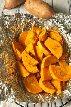 some sweet potatoes are sitting on tin foil