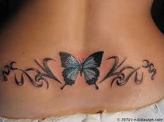 a woman's stomach with a butterfly tattoo on it