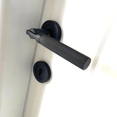 a door handle on a white door with black handles