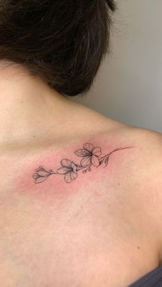 a woman with a flower tattoo on her back