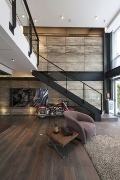 a living room filled with furniture and a stair case