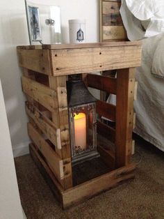 a small wooden table with a lit candle in it