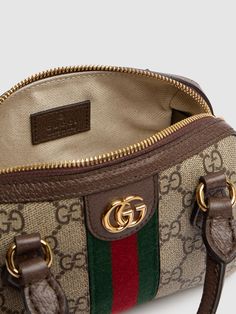 Find GUCCI Ophidia Canvas Shoulder Bag on Editorialist. This GUCCI shoulder bag is crafted from beige and ebony GG Supreme canvas with brown leather trim and gold-toned hardware. The bag features a green and red Web, a double G, and a zip closure. It has a detachable adjustable strap and double top handles. The bag measures 10cm in height, 16.5cm in width, and 9cm in depth. The strap drop is 54cm and the handle drop is 4.5cm. It features an internal keychain hook and a cotton linen lining. The b Brown Gucci Crossbody Bag, Gucci Bag With Gold-tone Hardware And Top Handle, Gucci Top Handle Bag With Gold-tone Hardware, Gucci Brown Satchel Bag, Gucci Beige Crossbody Satchel, Gucci Crossbody Satchel With Top Carry Handle, Gucci Shoulder Bag With Leather Trim, Gucci Brown Coated Canvas Shoulder Bag, Brown Gucci Coated Canvas Shoulder Bag