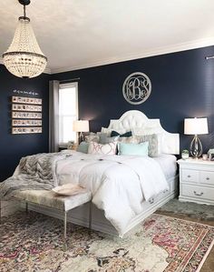 a large white bed sitting in a bedroom on top of a rug