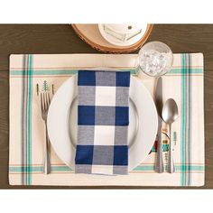 a place setting with blue and white plaid napkins, silverware and spoons