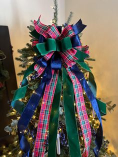 a christmas tree decorated with ribbons and lights