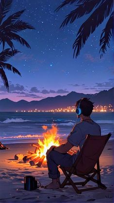 a man sitting in a chair next to a campfire at the beach with headphones on