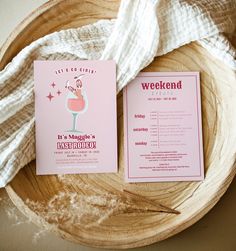 a pink menu sitting on top of a wooden plate next to a white towel and napkin