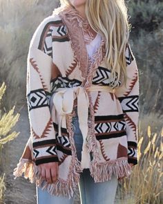 A stunning knit blanket sweater that is perfectly cozy for the season. Open front & soft fringe fold over collar. Color: Cream, camel & black Poly Hand wash cold Model is a size 8 wearing a medium. Small Medium Large Bust 50 52 53 Waist 49 51 52 Hips 51 53 54 Length 31 31 31 Bust, waist, and hip measurements are a total circumference. Length is measured from the top of the shirt to the hem. Measurements are an estimate. Beige Shawl Collar Sweater Coat For Fall, Bohemian Soft Knit Sweater For Fall, Fall Bohemian Soft Knit Sweater, Brown Tasseled Outerwear For Fall, Bohemian Fall Soft Knit Sweater, Brown Tassel Outerwear For Fall, Fall Tassel Long Sleeve Sweater, Beige Shawl Collar Sweater For Fall, Bohemian Beige Sweater For Fall