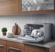 a dishwasher sitting on top of a kitchen counter