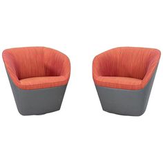 two orange and grey chairs sitting next to each other