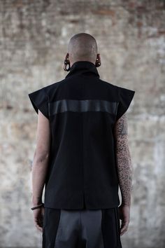 Black denim sleeveless jacket designed with vegan leather stripes. High neck closure and 2 side pockets. On the picture combined with our Hecto Pants. The model on the picture is wearing size M. His height is 181. Collection 'DEMON' 21 Fitted Urban Vest For Streetwear, Edgy Black Vest For Streetwear, Alternative Black Vest For Streetwear, Black Alternative Style Vest For Streetwear, Black Alternative Streetwear Vest, Sleeveless Jacket, Jacket Design, Macedonia, Black Denim