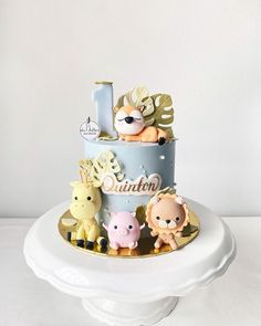 a three tiered cake with animals on it