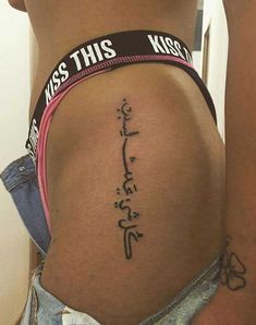 the back of a woman's stomach with writing on it