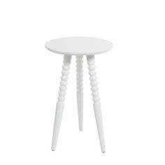 a small white table with three legs and a round top, on a white background