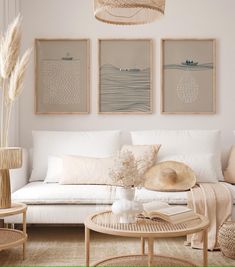 a living room filled with white furniture and pictures on the wall above it's coffee table