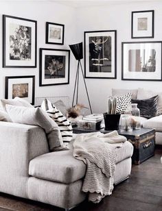 a living room filled with furniture and pictures on the wall