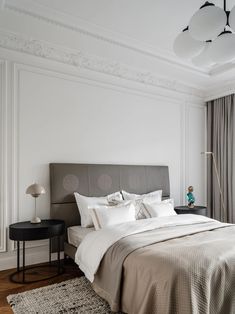 a bedroom with a large bed and white walls